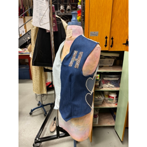 Blue and white handmade vest with the glittery letter H.