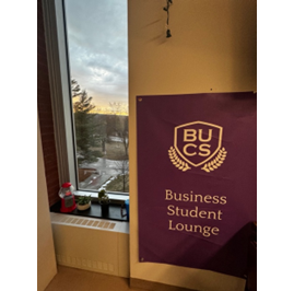 Purple poster marking the Business Student Lounge.