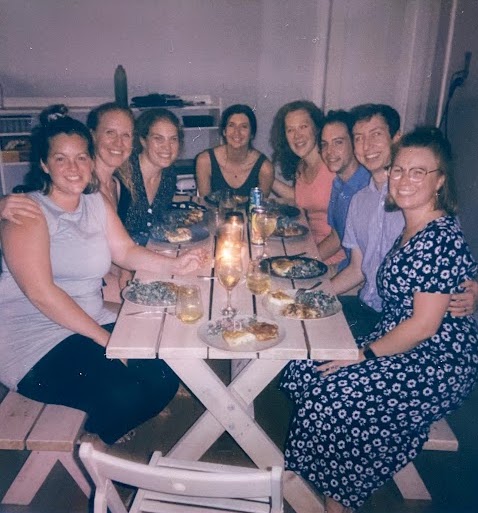 Group of friends around a table with food.