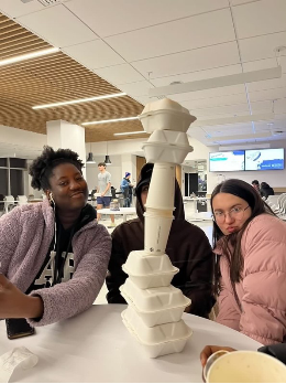 three friends with food plate stack tighter