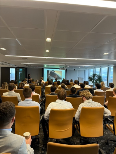 Room filled with student attending a event and sitting down