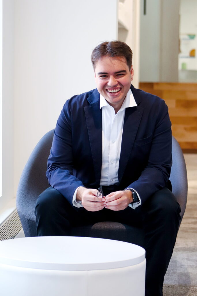 men sitting on a chair smiling